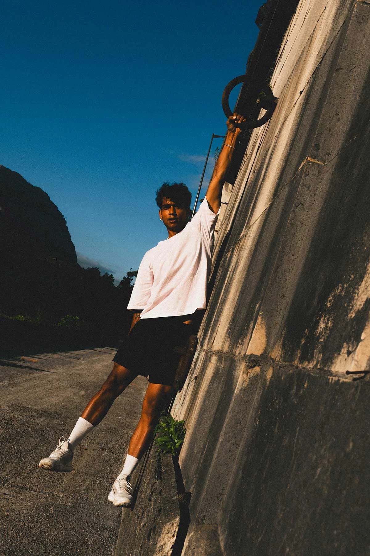Man hanging from a ledge during parkour