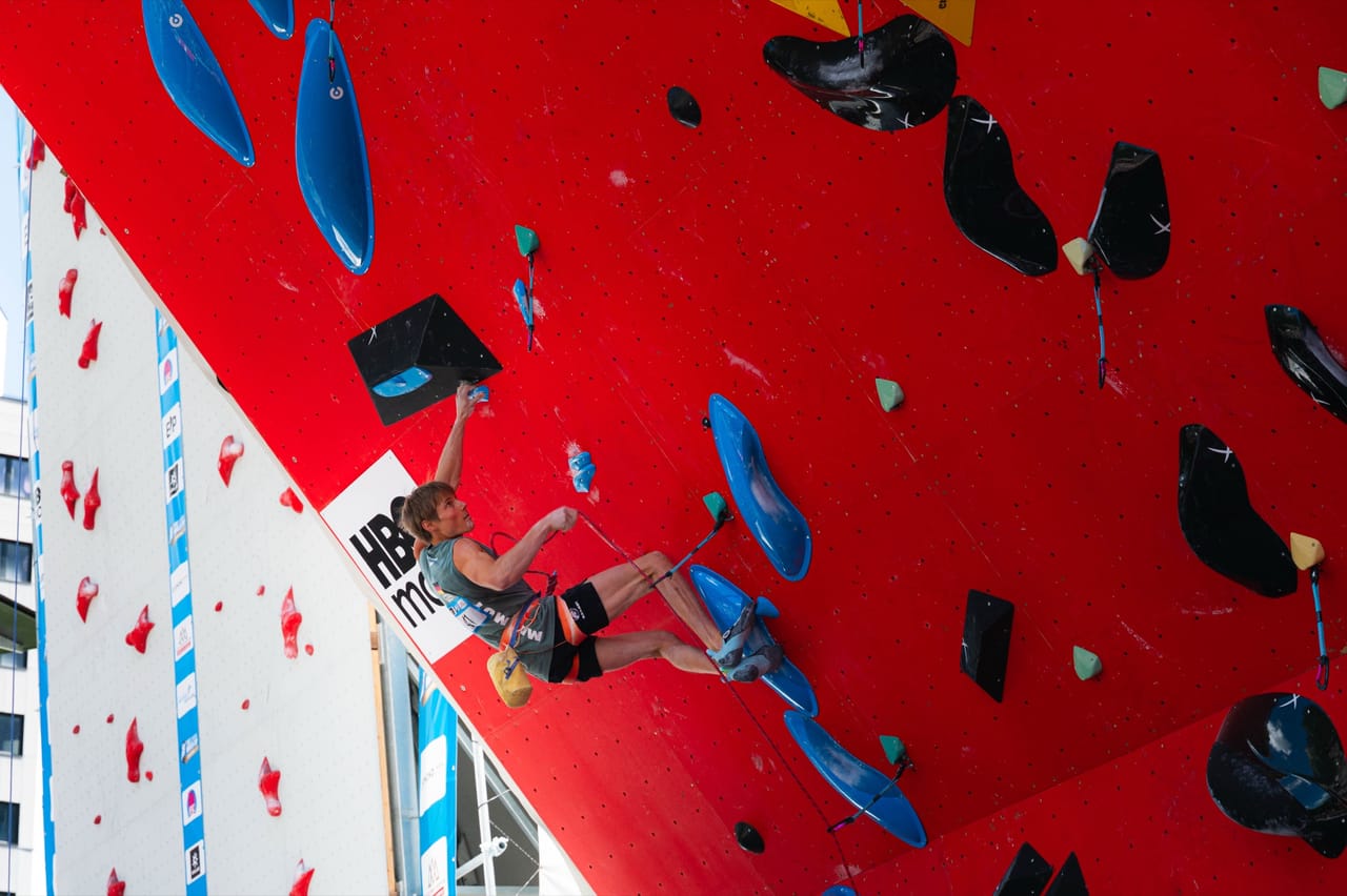 Climber on the overhanging red lead wall, HBO Max banner visible