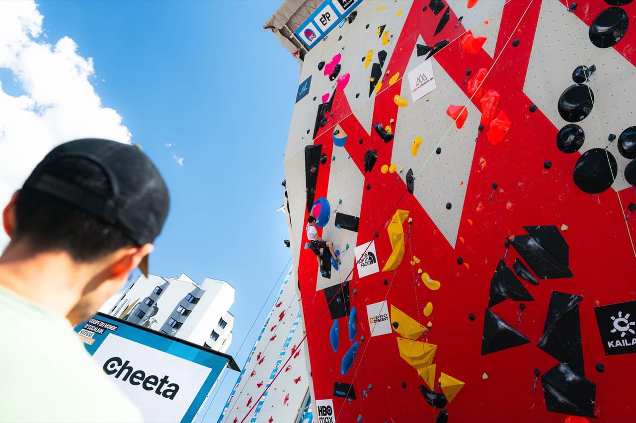 Wide view of the full competition wall with a spectator watching in the foreground