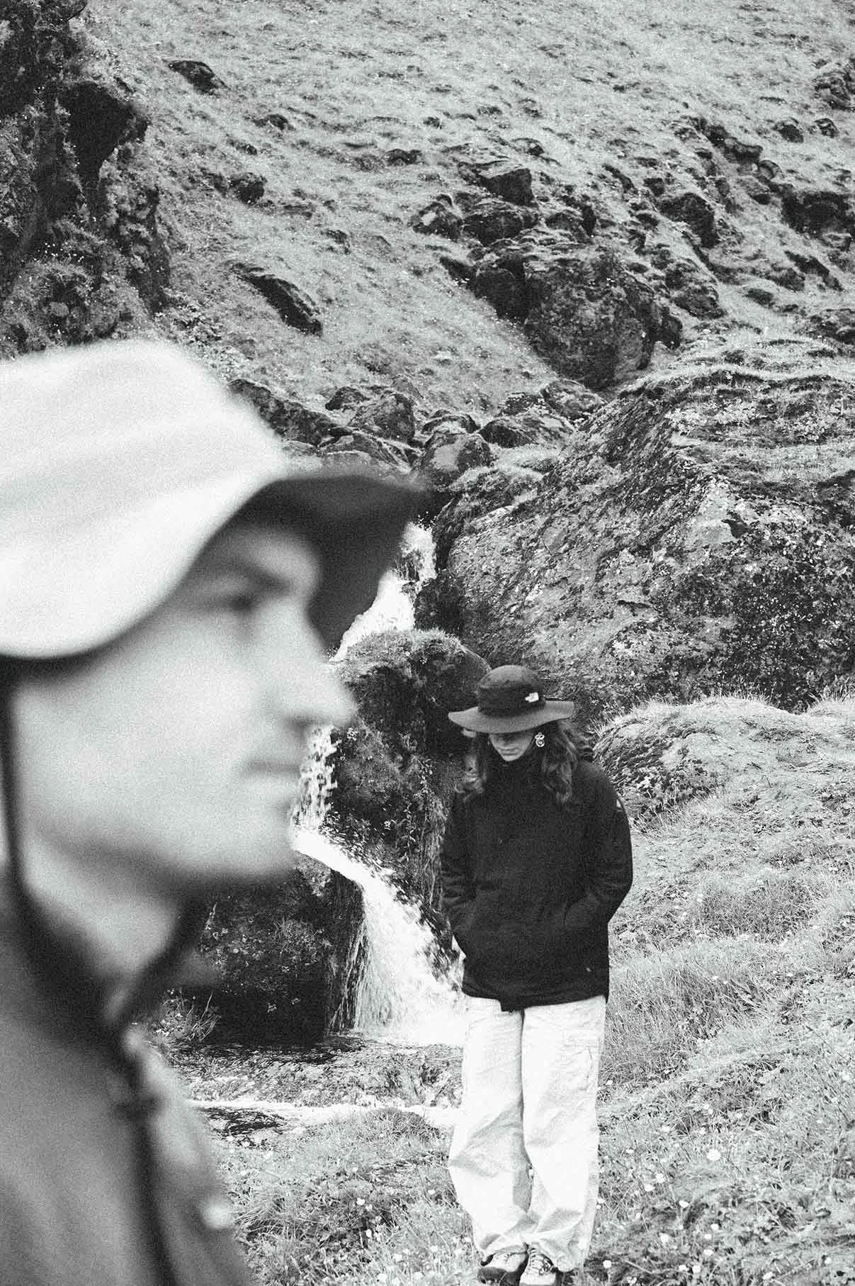 People outdoor by a waterfall
